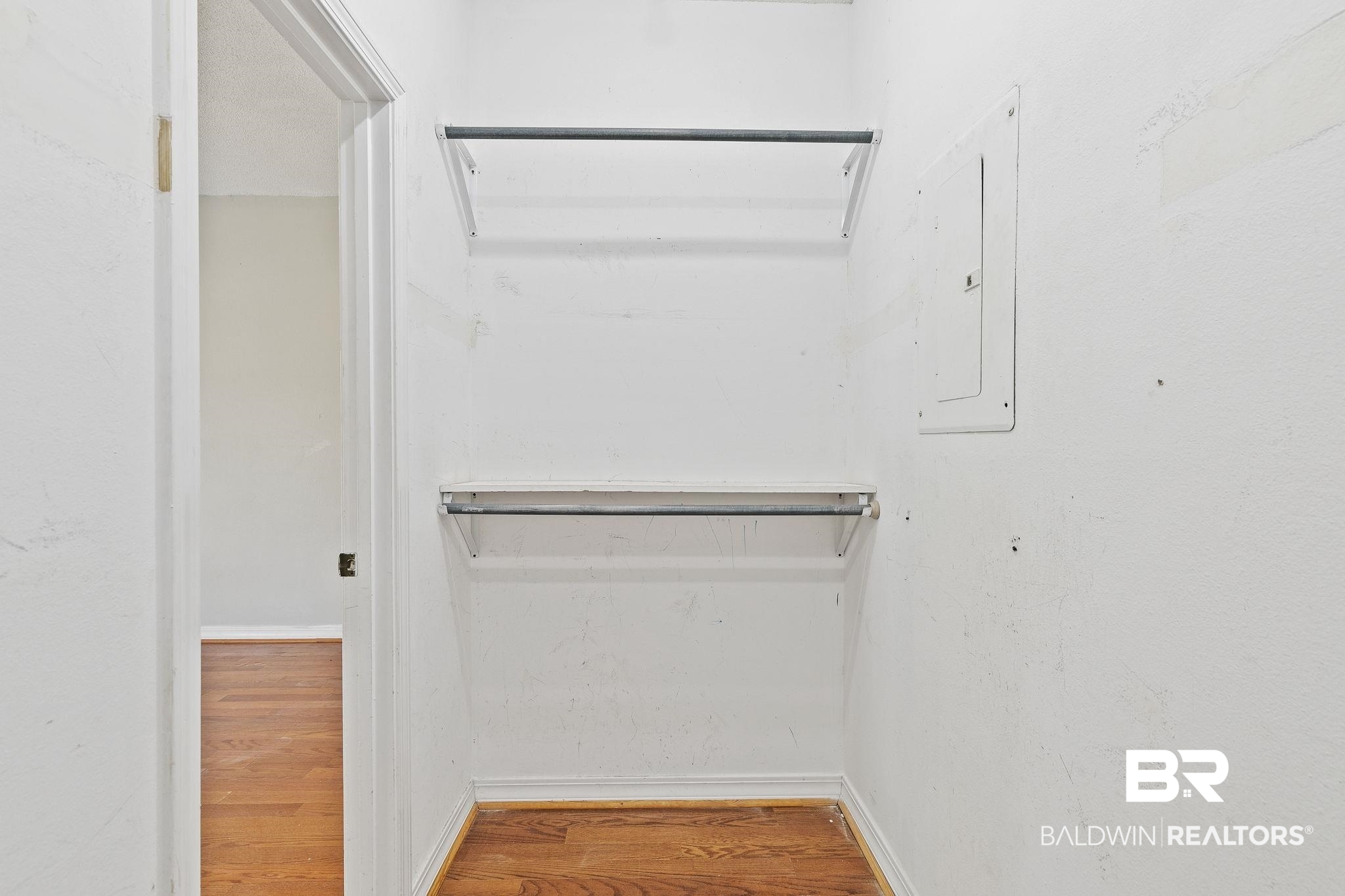 474 Ridgewood Drive Daphne, AL 36526 - Photo 31 of 57 Walk in closet with electric panel and hardwood / wood-style flooring
