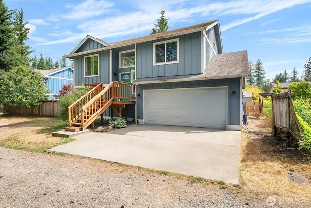 a view of a house with wooden fence
