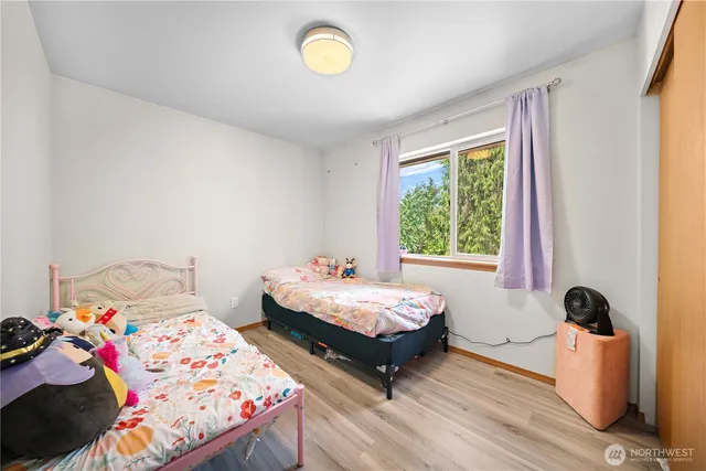 a bedroom with bed and a window