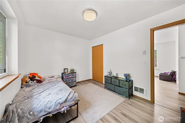 a bedroom with furniture and a wooden floor