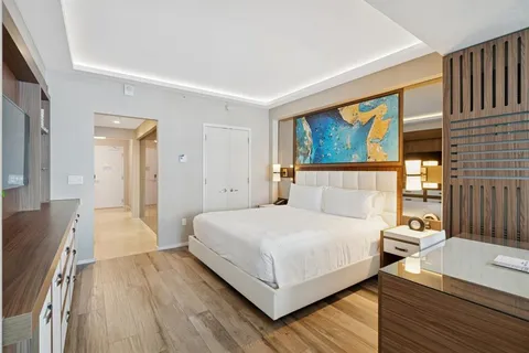 a bedroom with a bed and a flat screen tv