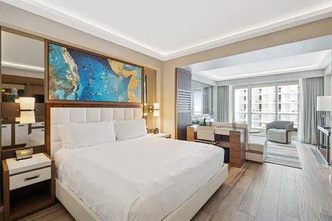 a bedroom with a large bed and a large window