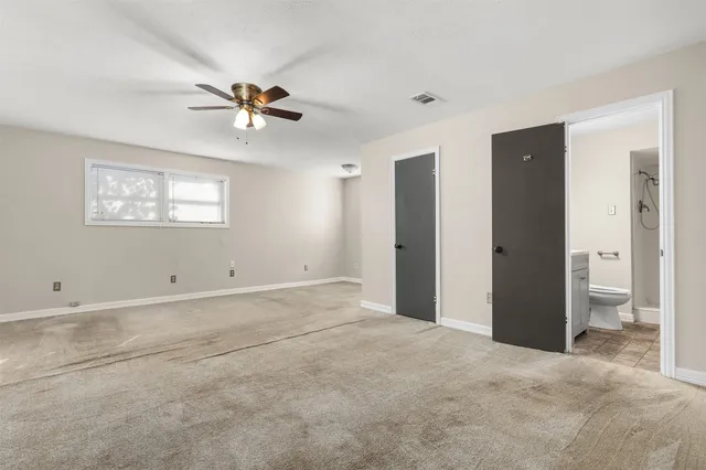 a view of a bedroom with closet and window