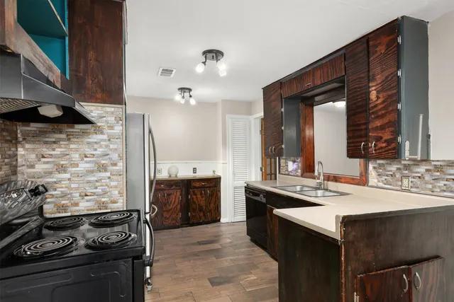 a kitchen with a stove and a sink