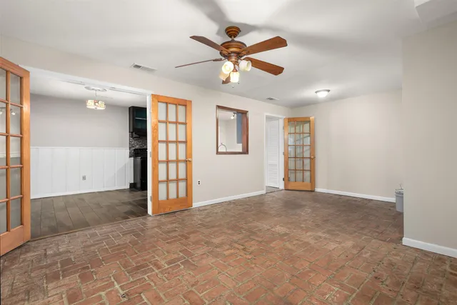 an empty room with fan and ceiling fan