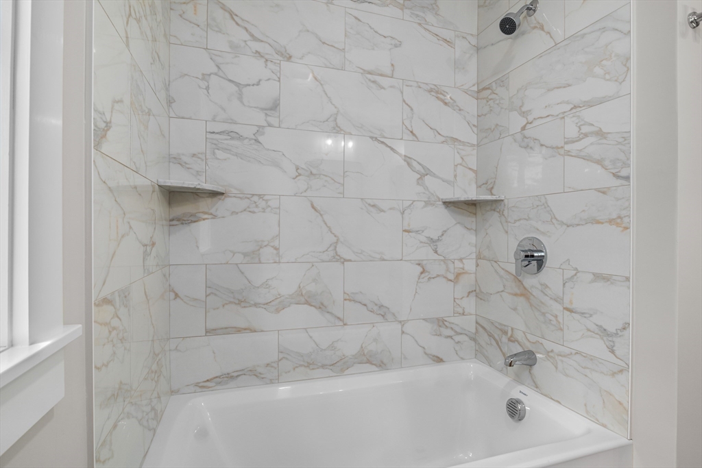 1549 Washington Street, Unit A Walpole, MA 02081 - Photo 9 of 11 a bathroom with a bathtub