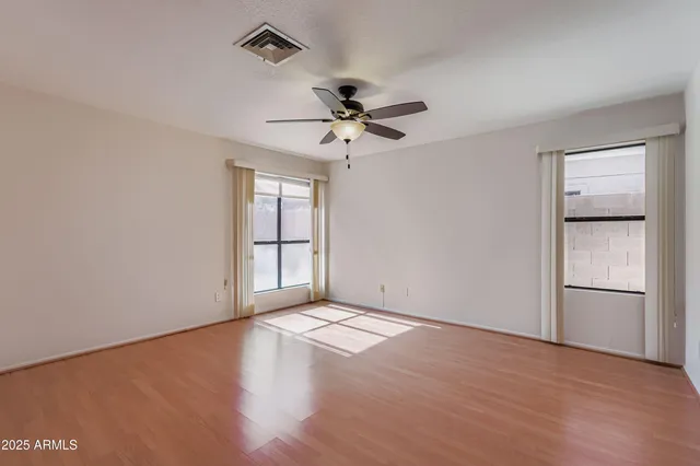 wooden floor in an empty room with a window