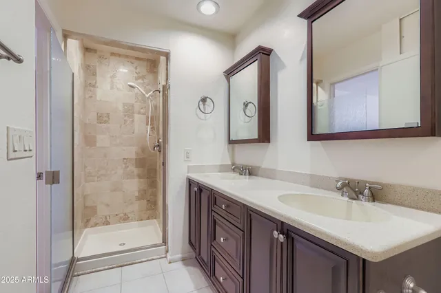 a bathroom with a shower sink and mirror