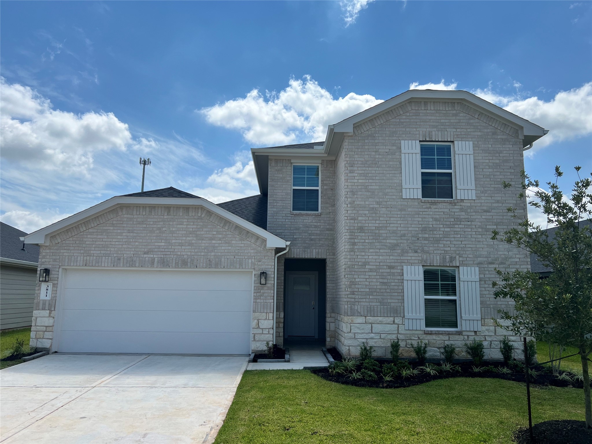a front view of a house with a garden