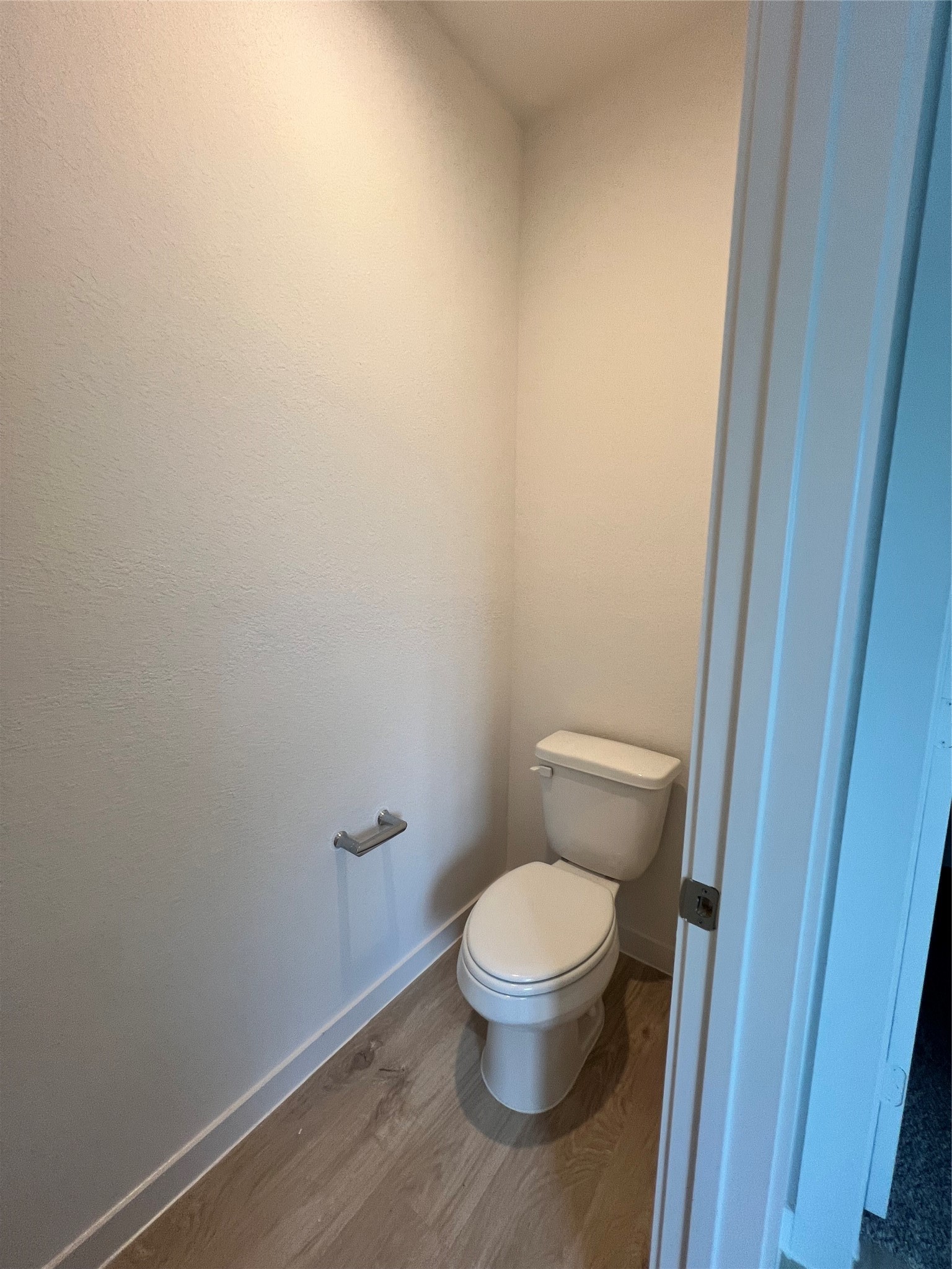 3811 Winterbourne Way Fulshear, TX 77441 - Photo 14 of 22 a white toilet sitting next to a wooden cabinet