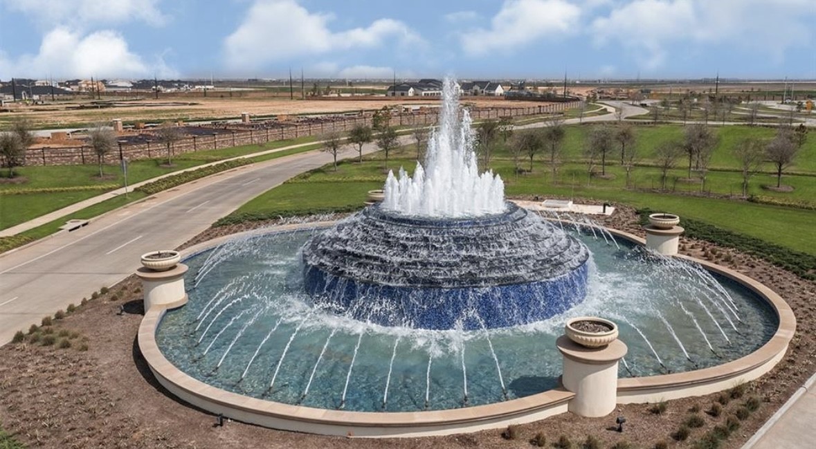 3811 Winterbourne Way Fulshear, TX 77441 - Photo 18 of 22 a view of a swimming pool with a lawn chairs and a lake view