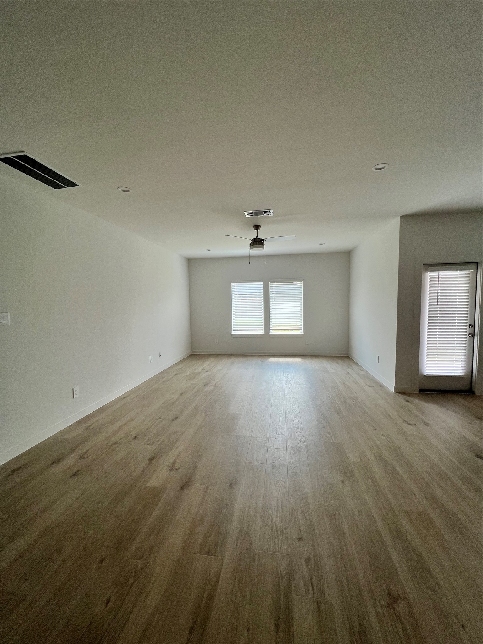 3811 Winterbourne Way Fulshear, TX 77441 - Photo 4 of 22 wooden floor in an empty room with a window