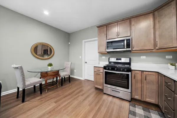 a large kitchen with stainless steel appliances granite countertop a stove sink and cabinets