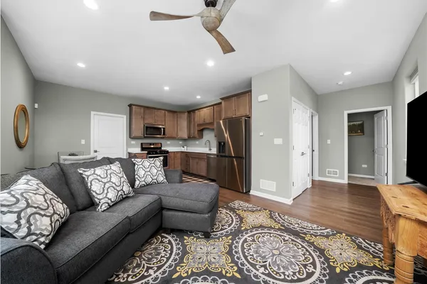 a kitchen with stainless steel appliances kitchen island granite countertop a sink and cabinets
