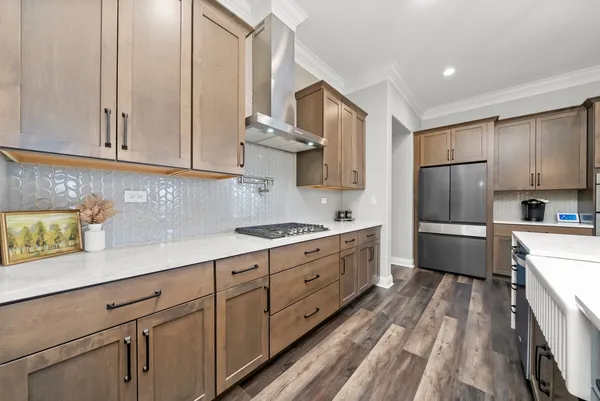 a kitchen with stainless steel appliances granite countertop a sink stove and refrigerator