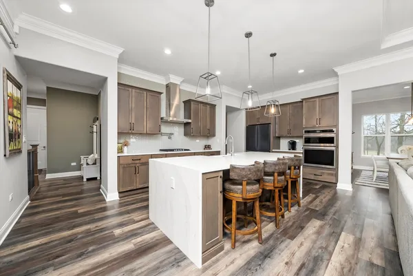 a kitchen with kitchen island a sink stainless steel appliances and window