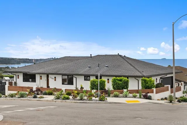 a living room with lots of furniture and a large window