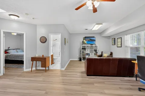 a living room with furniture and a wooden floor