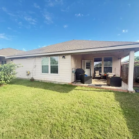 a view of a house with swimming pool and a yard