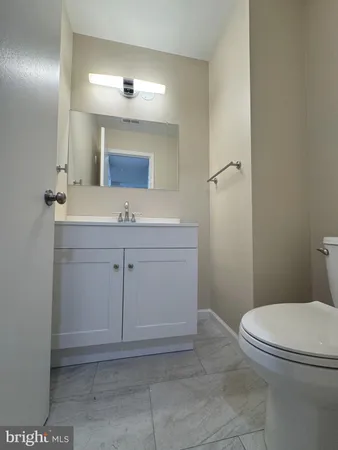 a bathroom with a sink a toilet and mirror