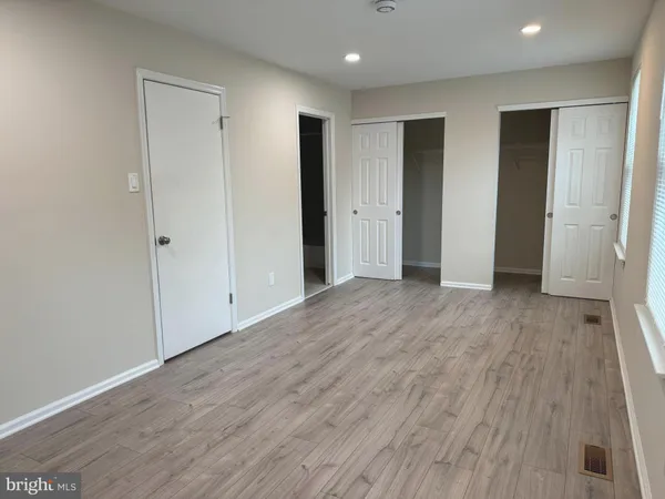 a view of hallway with wooden floor