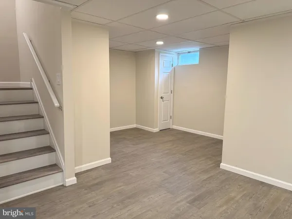 a view of an empty room with stairs and ventilation