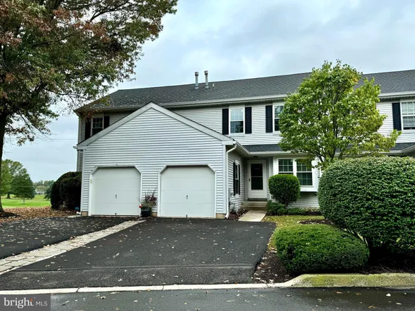 a view of white house with a yard