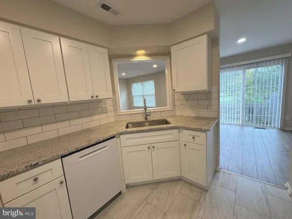 a kitchen with sink cabinets and window