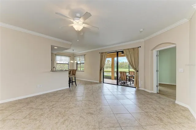 a kitchen with granite countertop a stove cabinets and chairs