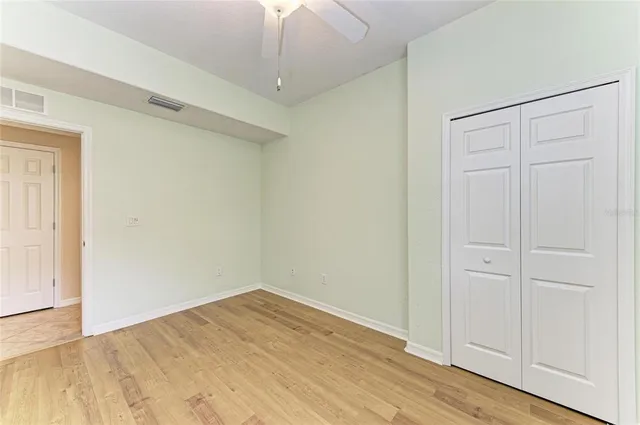 a view of a city with lawn chairs and large trees