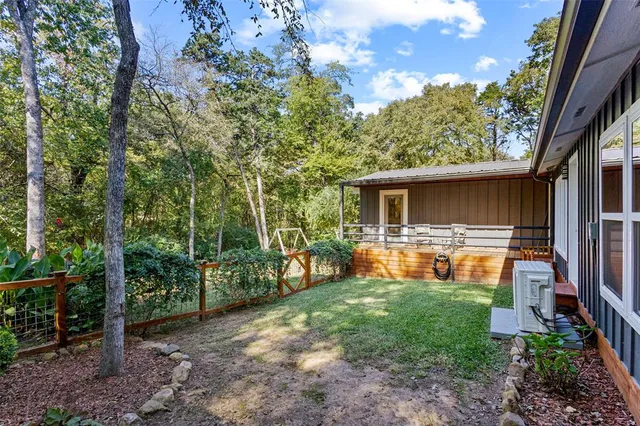 a backyard of a house with table and chairs