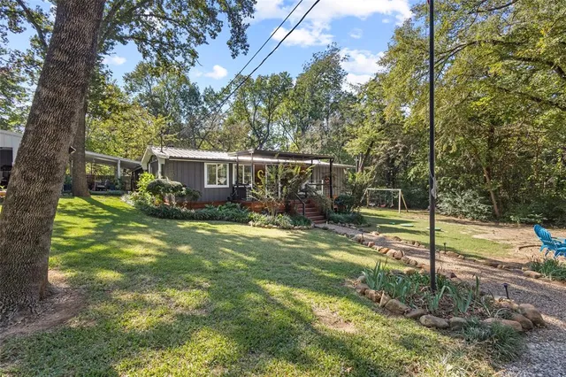 a view of a house with backyard and sitting area