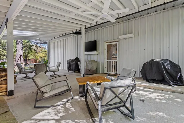 a outdoor living space with furniture and a flat screen tv