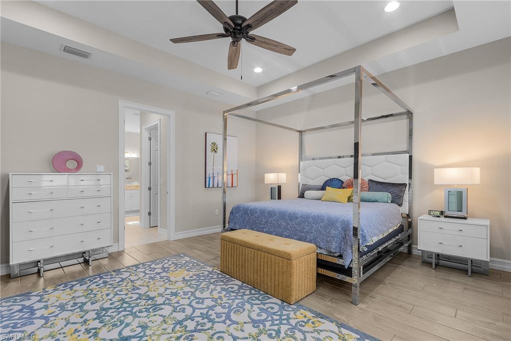 14539 Kelson Circle Naples, FL 34114 - Photo 12 of 37 Primary Bedroom featuring wood finish floors, ceiling fan, and recessed lighting