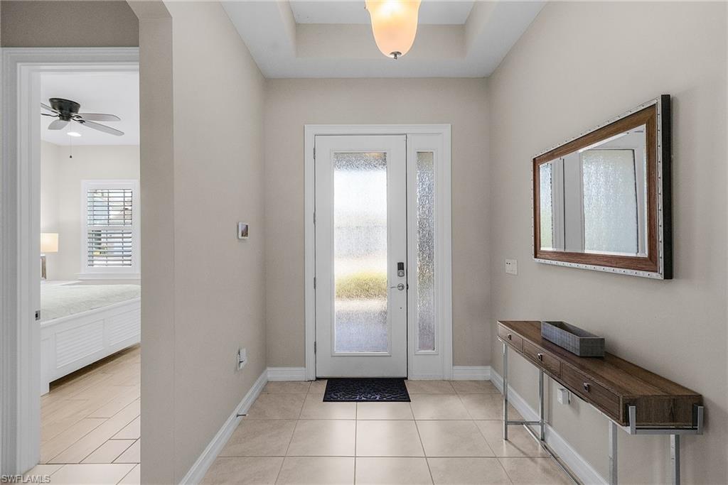 14539 Kelson Circle Naples, FL 34114 - Photo 5 of 37 Foyer entrance with light tile patterned floors and a ceiling fan