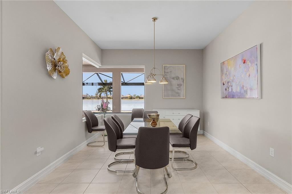 14539 Kelson Circle Naples, FL 34114 - Photo 9 of 37 Dining room with light tile patterned floors and a water view