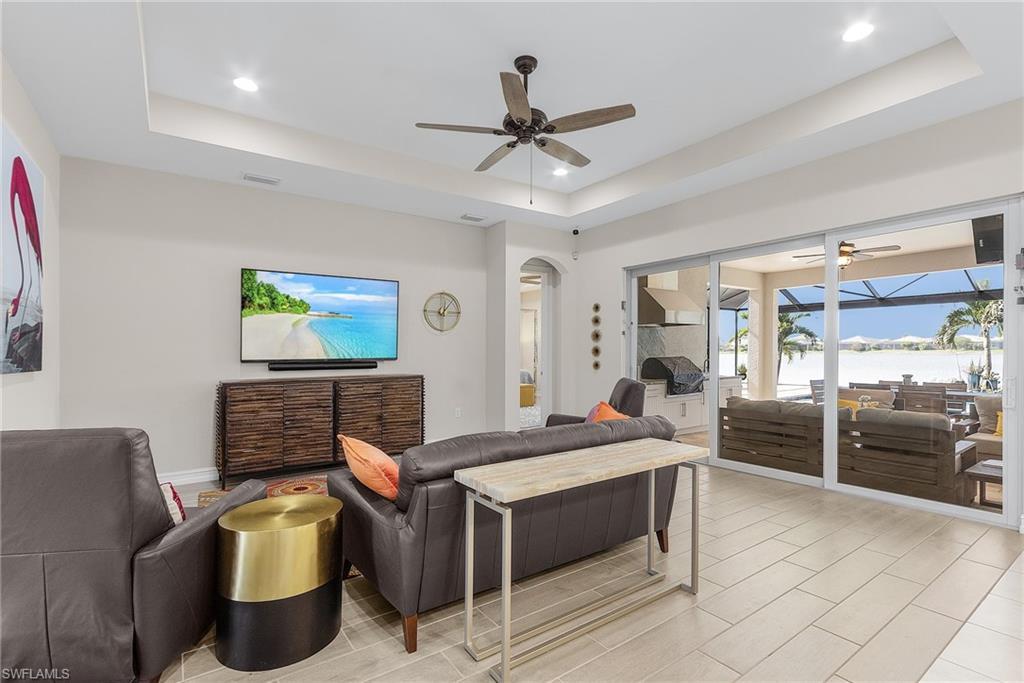 14539 Kelson Circle Naples, FL 34114 - Photo 10 of 37 Living area with a tray ceiling, ceiling fan, recessed lighting, and arched walkways