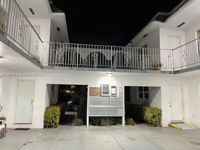 a view of front door with potted plants