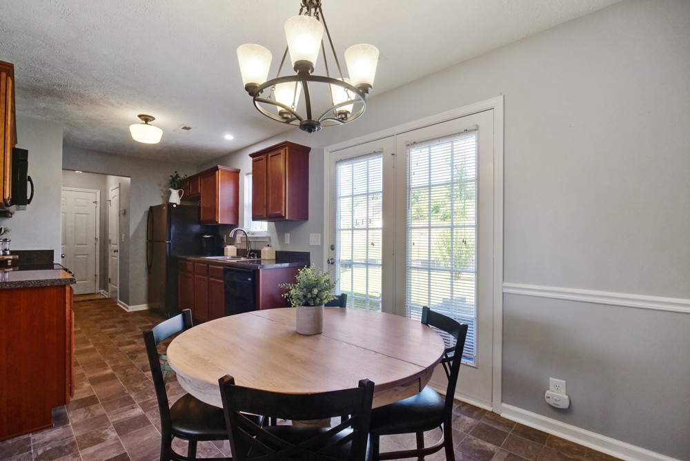 1030 Woodall Road Lebanon, TN 37090 - Photo 8 of 27 a view of a dining room with furniture a chandelier and wooden floor