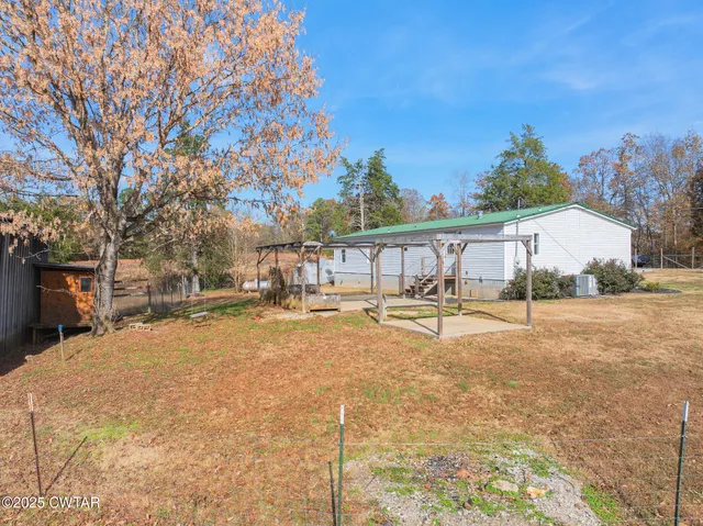 a view of pool with a yard