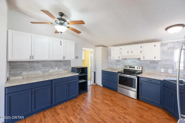 a kitchen with stainless steel appliances granite countertop a sink and cabinets