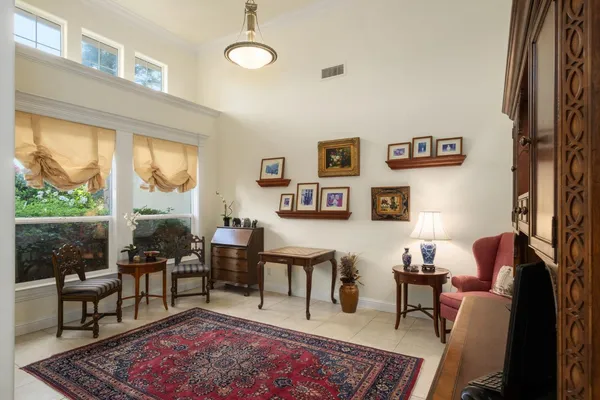 a living room with furniture wooden floor and a table