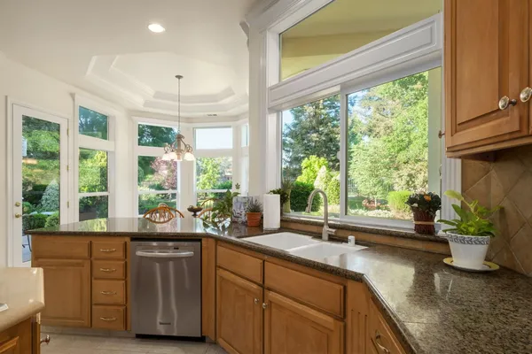 a kitchen with sink and large window