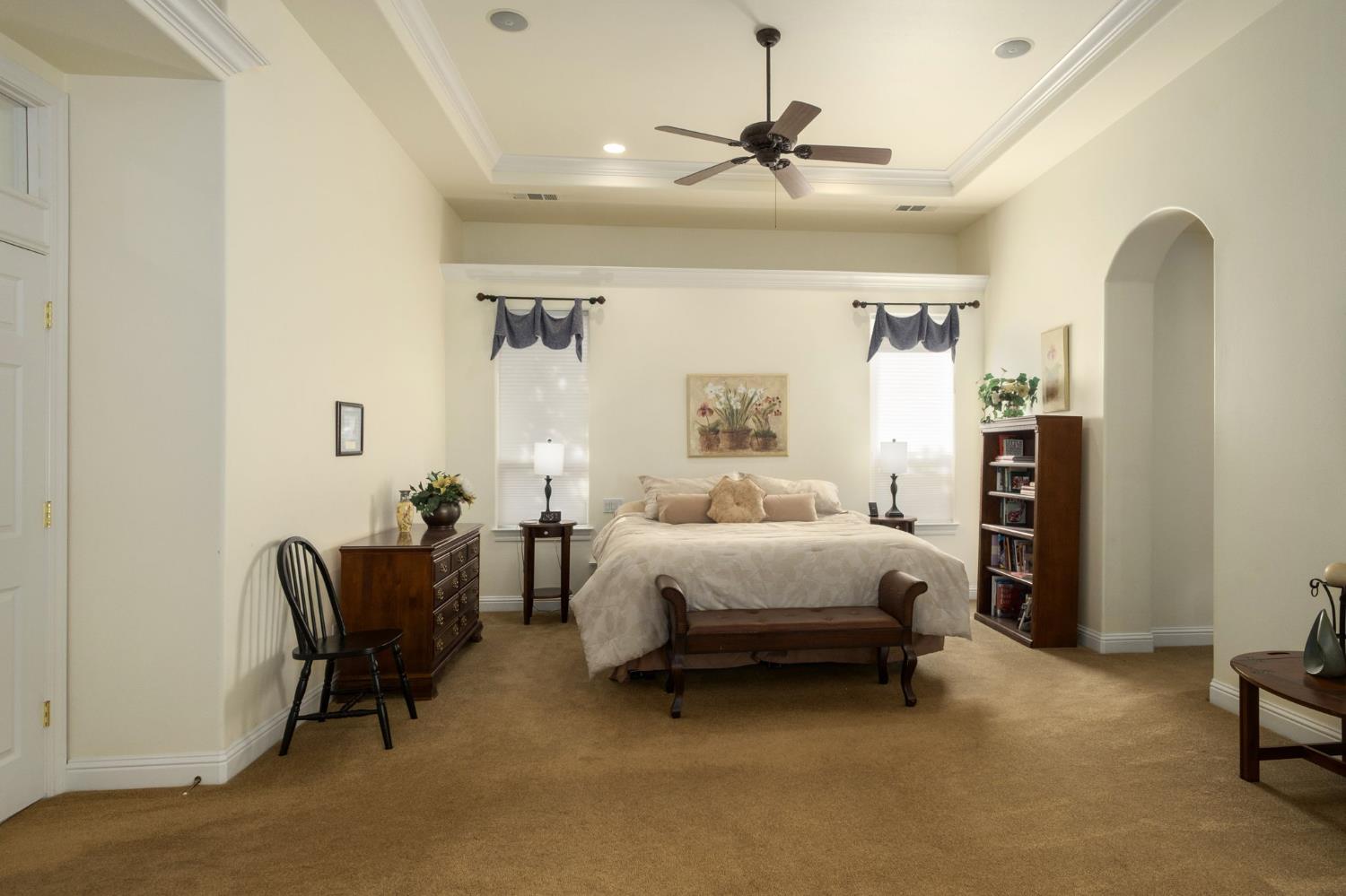 3386 East Vía Monte Verdi Clovis, CA 93619 - Photo 25 of 51 a bed room with a bed and a chair