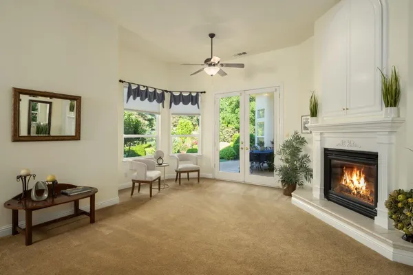 a living room with furniture and a fireplace