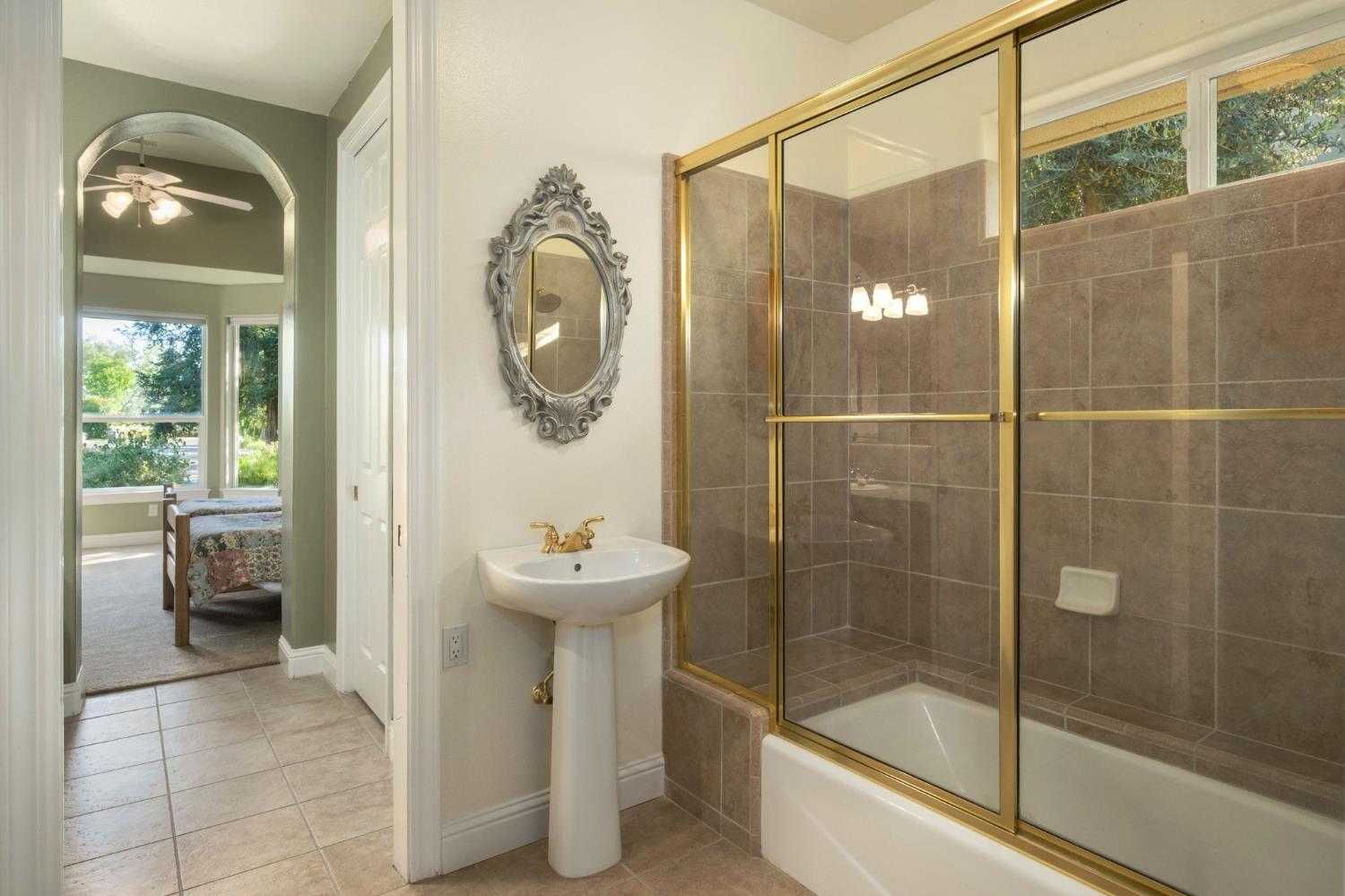 3386 East Vía Monte Verdi Clovis, CA 93619 - Photo 31 of 51 a bathroom with a sink toilet and shower