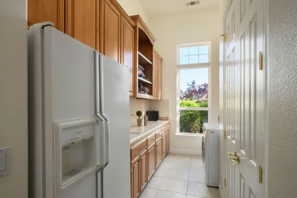 a kitchen with a cabinets and refrigerator