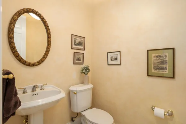 a bathroom with a toilet sink and mirror