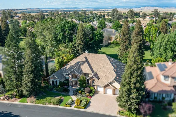 an aerial view of a house with yard