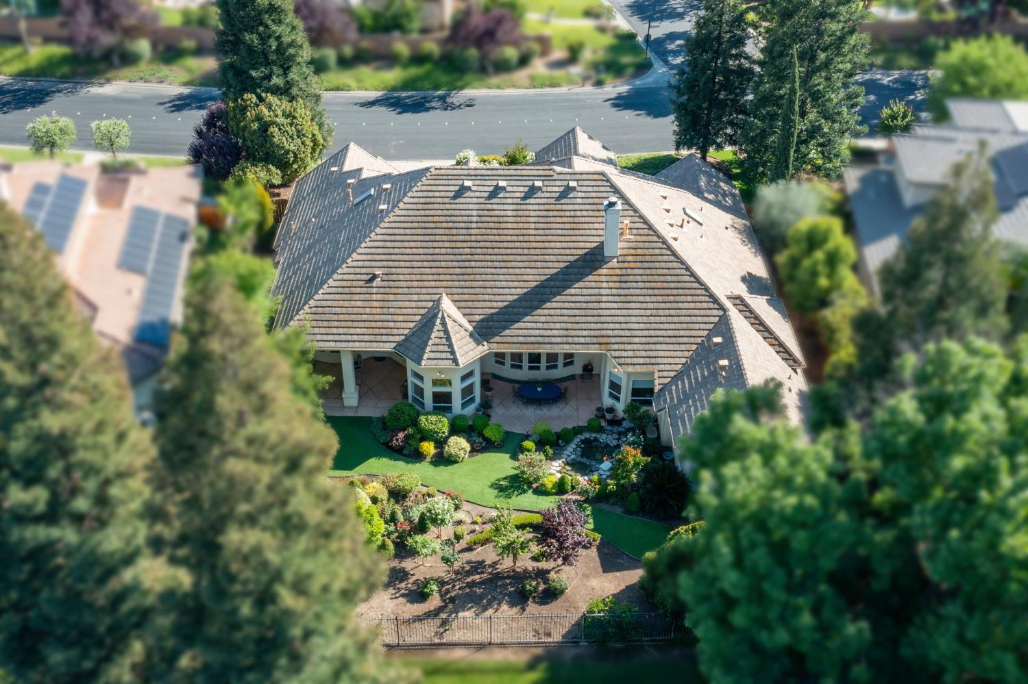 3386 East Vía Monte Verdi Clovis, CA 93619 - Photo 45 of 51 a aerial view of a house with a yard and potted plants
